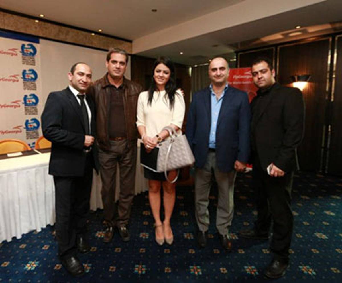 Image from the now no-longer existent Facebook page of Fly Georgia: Houshang Hosseinpour (second from left), his daughter Tannaz (center), and Pourya Nayebi (second from right) at a Fly Georgia corporate event, April 2013. (Courtesy Emanuele Ottolenghi)