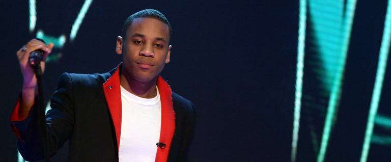Reggie Yates of 'Top Of The Pops' performs Lenny Kravitz's song, 'It Ain't Over 'Til It's Over,' as part of 'Comic Relief Does Fame Academy' at Lambeth College on March 3, 2005 in London.