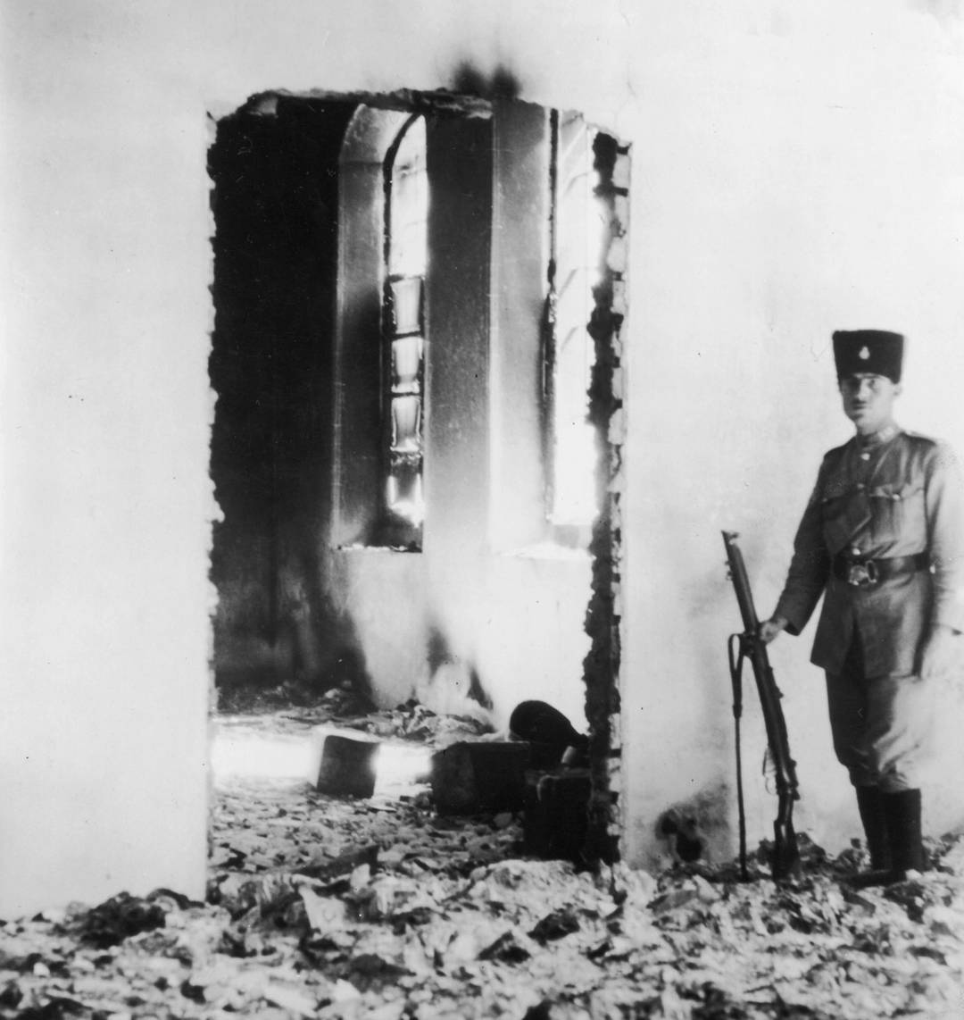 A soldier standing guard in the ruins of a Jewish hospital in Hebron after it was pillaged by Arabs, August 1929. Sixty-seven unarmed Jewish men, women, and children were murdered that day.