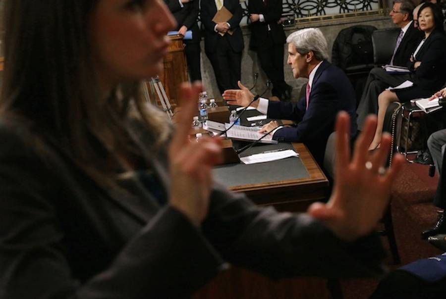 A sign language interpreter signs for the hearing impared as U.S. Secretary of State John Kerry testifies before the Senate Foreign Relations Committee in November 2013(Getty)