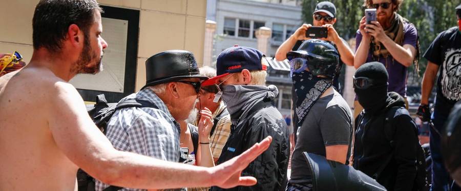An unidentified man faces off with Rose City Antifa members at Pioneer Courthouse Square on June 29, 2019, in Portland, Oregon.