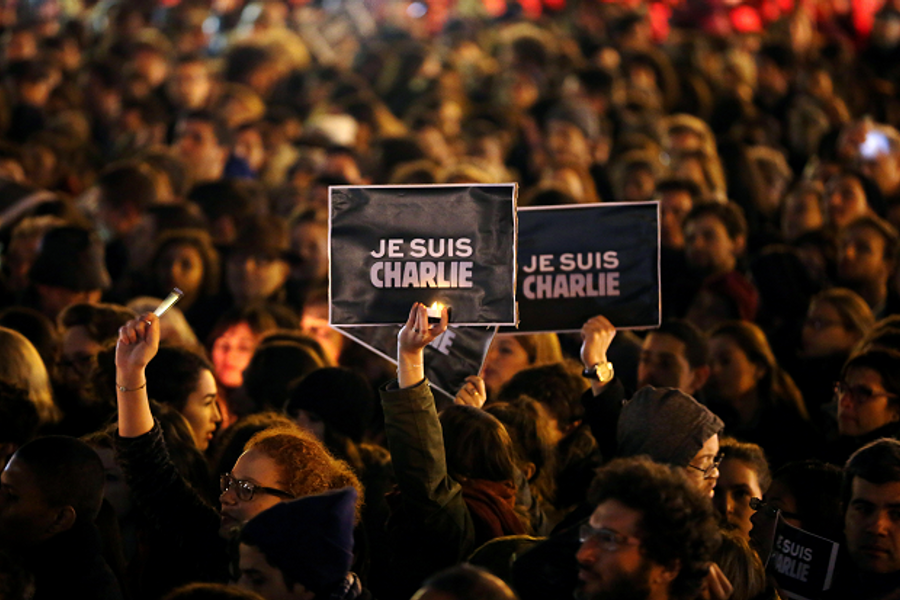 People hold a vigil at the Place de la Republique (Republic Square) for victims of yesterday's terrorist attack, on January 8, 2015 in Paris, France. (Getty Images)