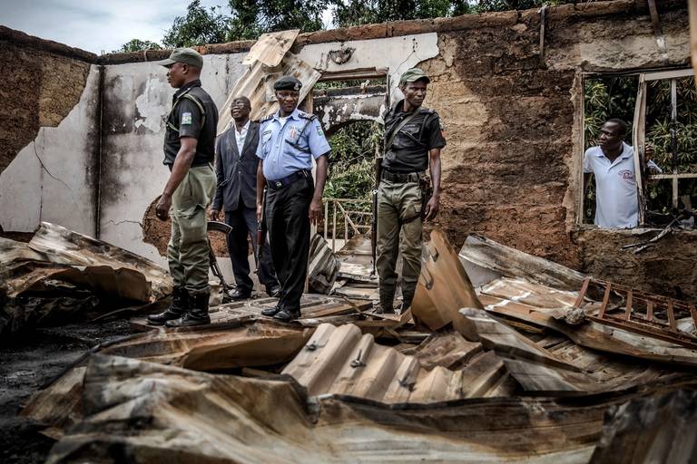 Nigerian police officers and Adara leaders visit and patrol an area of destroyed and burned houses after a recent Fulani attack in the Adara farmers’ village of Angwan Aku, Kaduna State, Nigeria on April 14, 2019