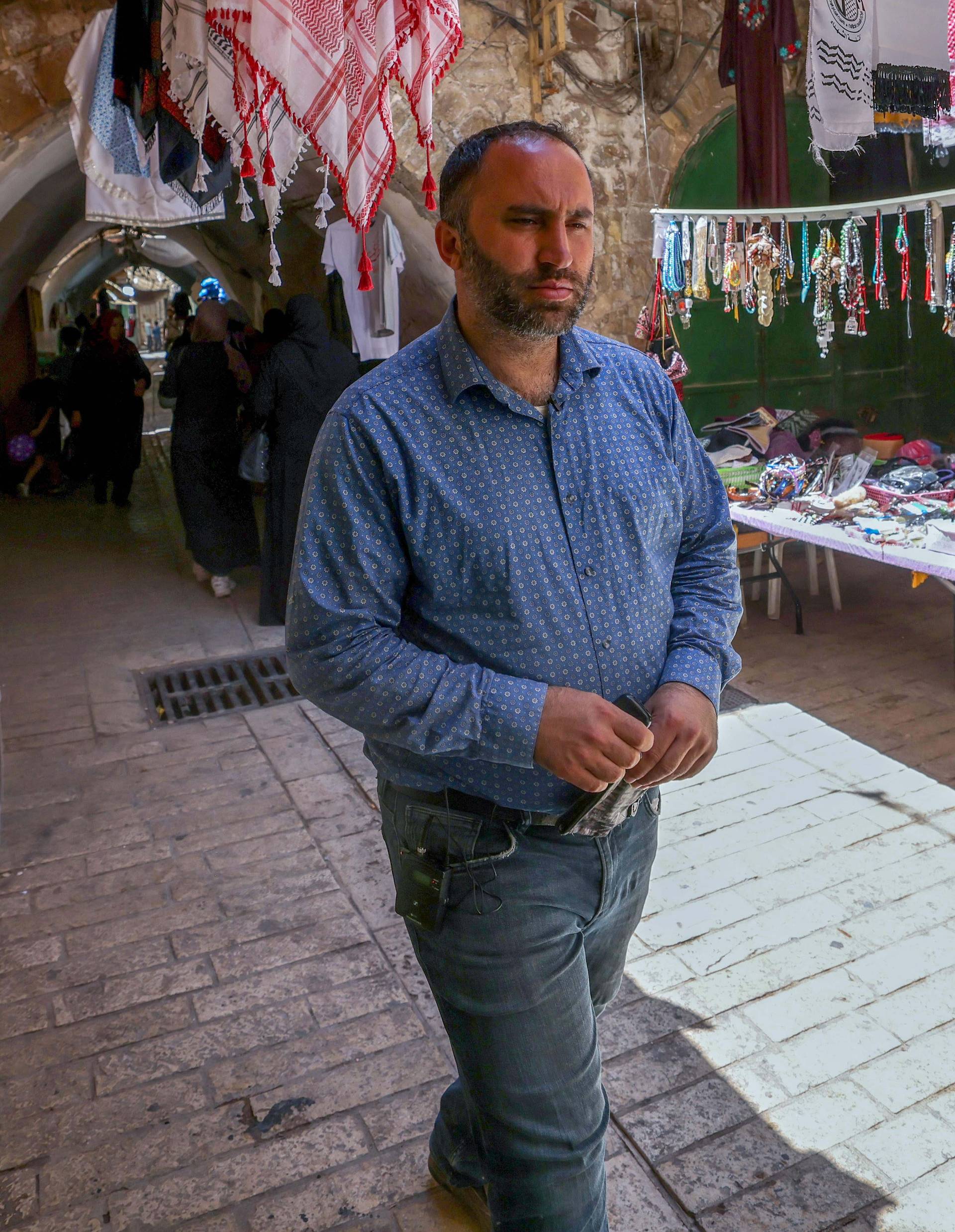 Issa Amro walks through the market of Hebron's Old City on June 27, 2021