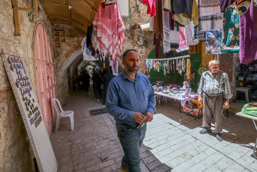 Issa Amro walks through the market of Hebron's Old City on June 27, 2021
