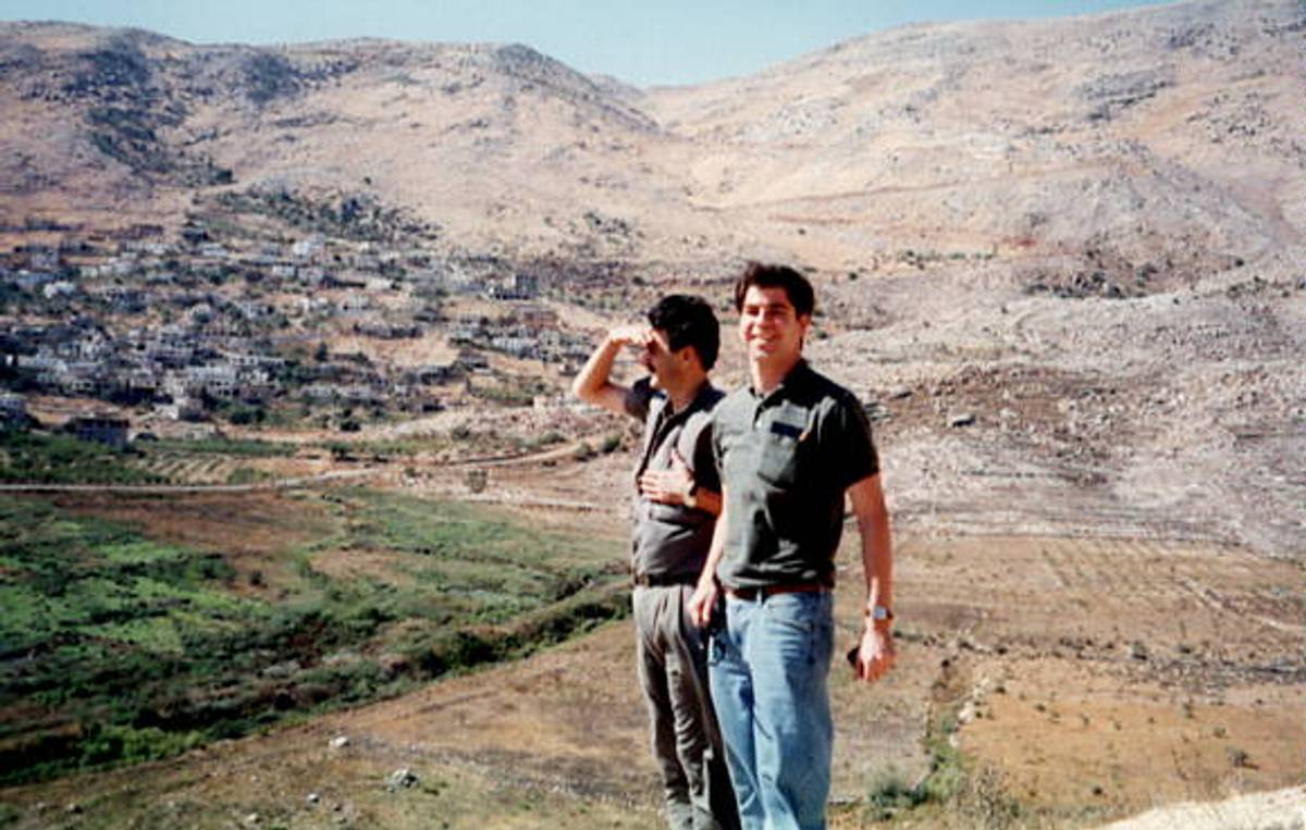 The author, at right, and his driver, on a windy day in Quneitra, looking south into the Israeli Golan