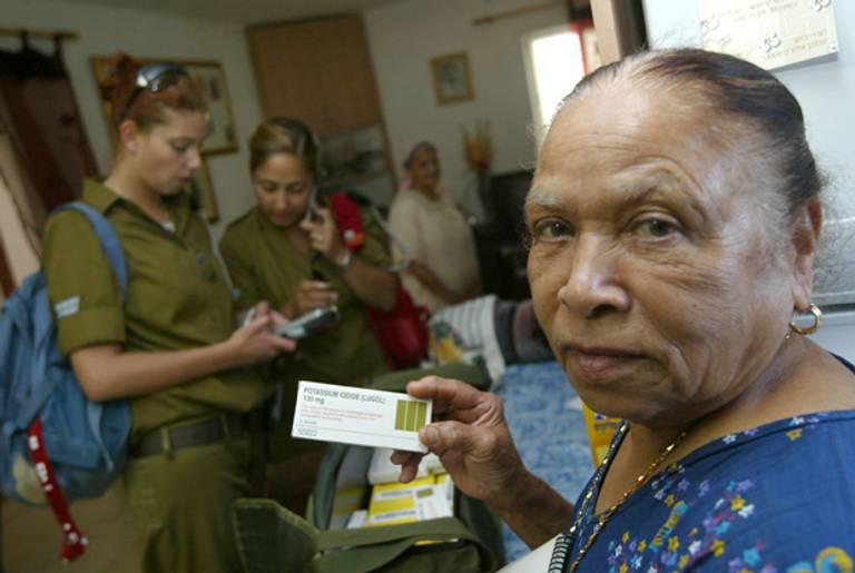 Hana Nalgurka holds her supply of Lugol capsules, an antidote to radiation, which was provided to her by Israeli soldiers in Dimona, in 2004. The antidote is intended to protect residents from radioactive fallout should any missile attack on the nuclear station occur, or in case of a reactor accident.(David Silverman/Getty Images)