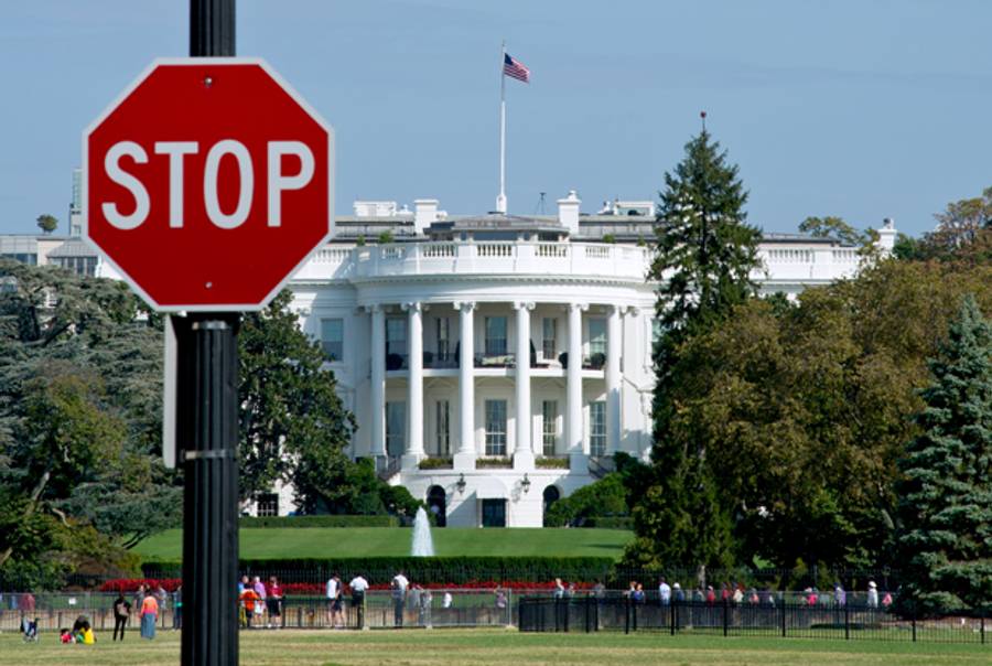 The White House is seen behind a stop sign in Washington, DC, on October 1, 2013. The US government shut down Tuesday for the first time in 17 years after a gridlocked Congress failed to reach a federal budget deal amid bitter brinkmanship. (KAREN BLEIER/AFP/Getty Images)