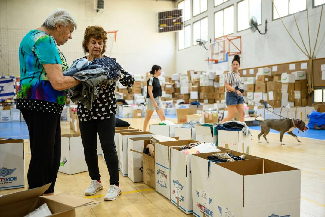 Volunteers sort donated clothes for those who have been forced to flee their homes following the Hamas attacks of Oct. 7, at a sports gym on Oct. 24, 2023, in Ramat Gan, Israel