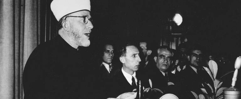 Amin Al-Husayni, the former grand mufti of Jerusalem, living in Nazi Germany from 1939 to 1945, at the opening of the Islamic Central Institute in Berlin, Germany. World War II, German army photograph, December 19, 1942.
