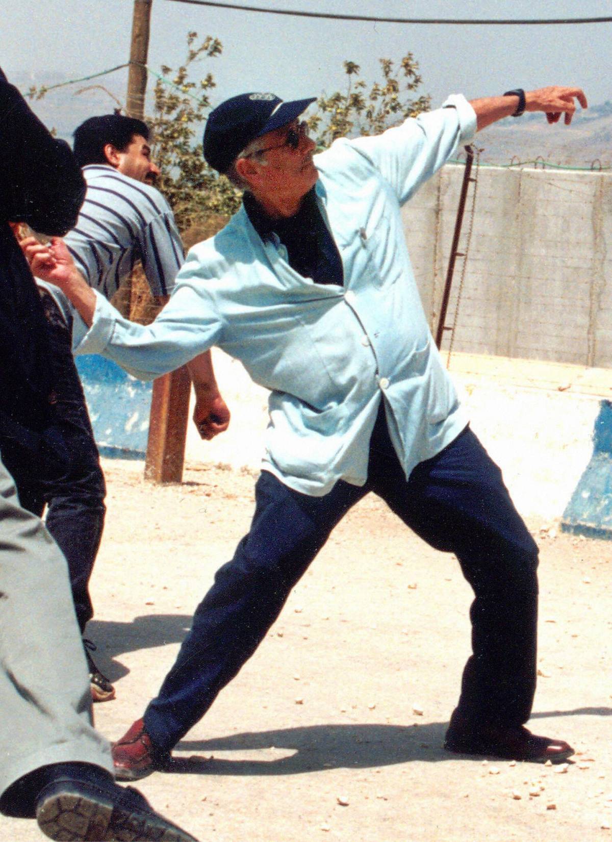 Edward Said launching a stone against Israeli soldiers on the other side of Lebanon's border with Israel from the southern Lebanese village of Kfar Kila, 2000