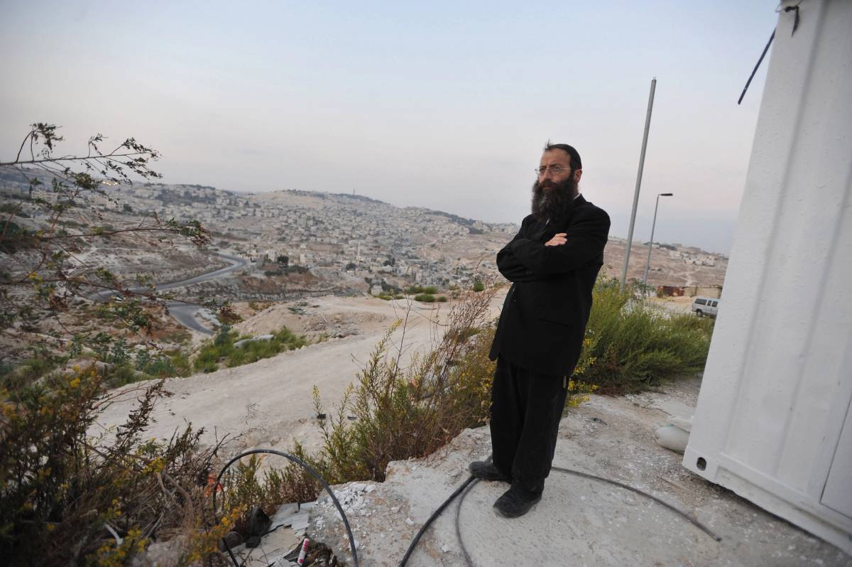 'Marzel told me that when he looks out his window at the increasingly cluttered hillsides of inscrutable sandstone high-rises forming the PA-controlled Hebron downtown a couple hundred meters away, he sees “a lot of Arabs that want to kill me.”’ Baruch Marzel overlooks Arab neighborhoods in East Jerusalem in 2009.