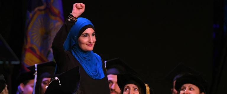 Linda Sarsour, co-organizer of the National Womens March and one of TIME Magazines 100 Most Influential People raises her fist as shes walks to the stage as the keynote speaker at the CUNY Graduate School of Public Healths inaugural commencement ceremony June 1, 2017 at the Apollo Theatre in Harlem.