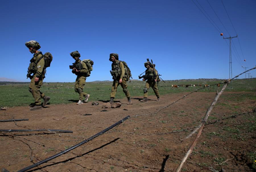 Israeli soldiers patrol along the Israel-Syria border on March 5, 2014. (JALAA MAREY/AFP/Getty Images)