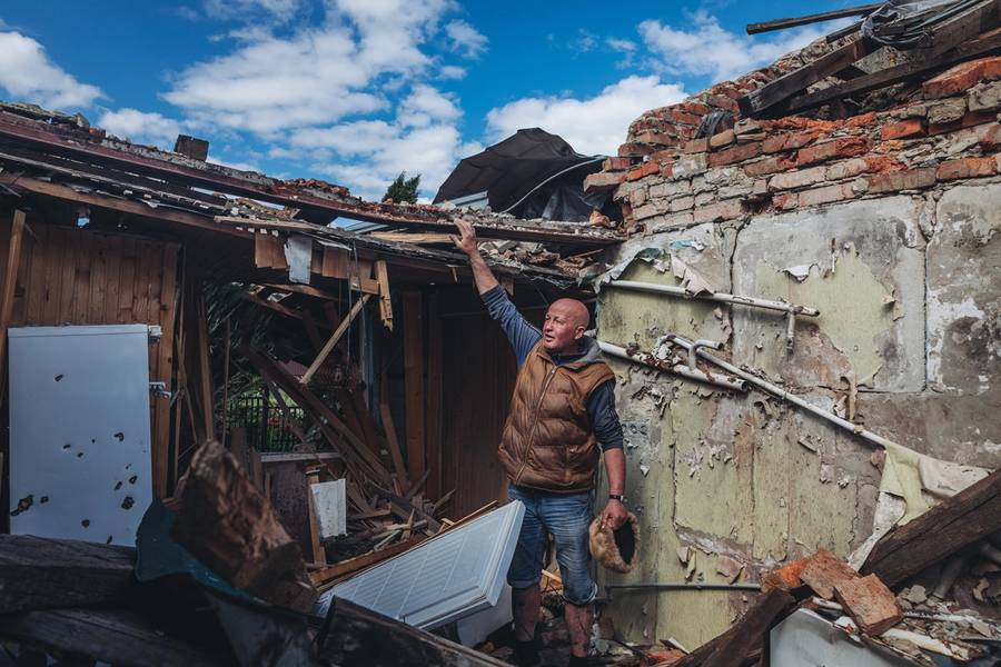 A man shows his destroyed house in Vilkhivka, near Kharkiv, Ukraine, on May 9, 2022