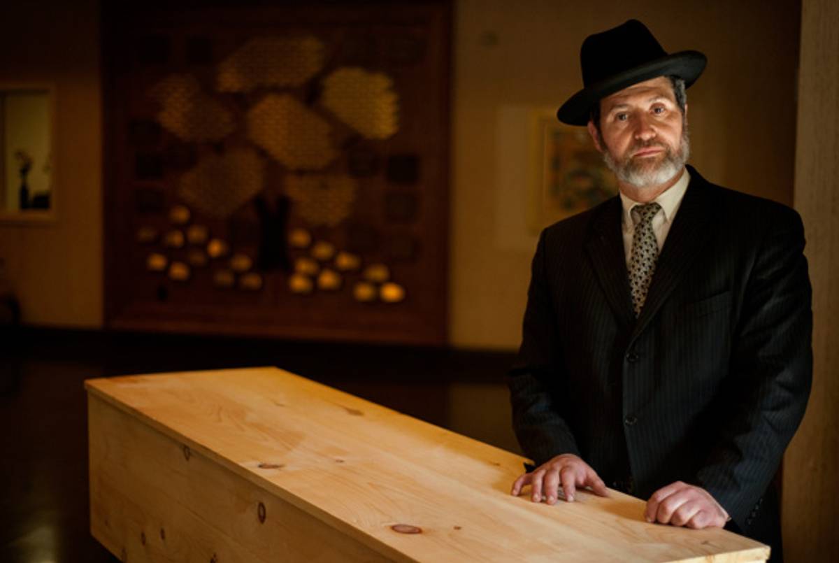 Rabbi Daniel Wasserman with a casket at the temple on Aug. 6, 2012.(Justin Merriman/Tribune Review)