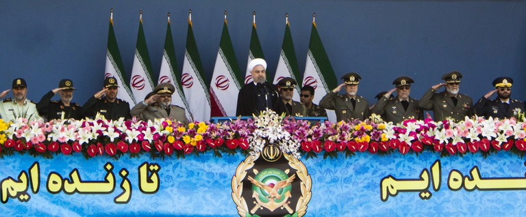 Iranian President Hassan Rouhani (left) and military commanders salute during the Army Day parade in Tehran on April 18, 2015. 