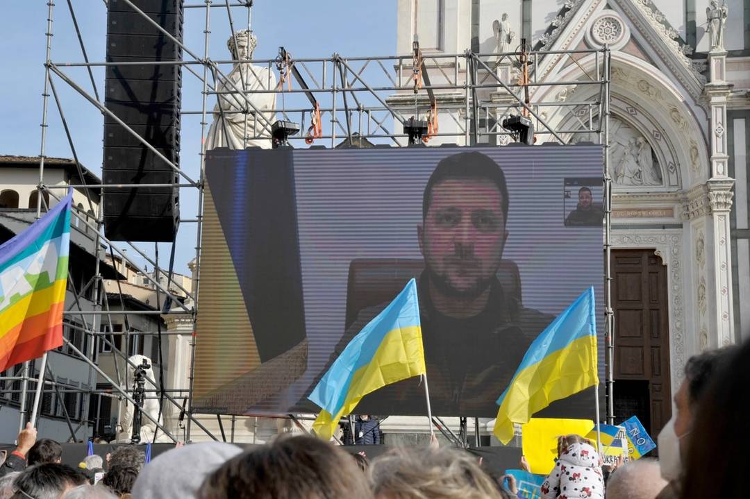 Ukrainian President Volodymyr Zelensky connects via live video link on a screen during the antiwar demonstration 'Cities stand with Ukraine' in Piazza Santa Croce in Florence, Italy, on March 12, 2022
