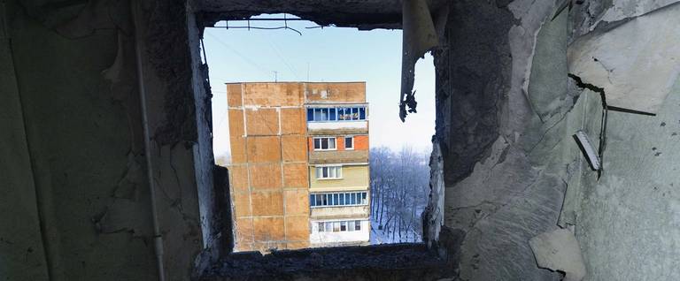 A view from a destroyed window after a shell hit an apartment block building in the Petrovsky district of the eastern Ukrainian city of Donetsk, which is controlled by Donetsk People's Republic rebels, in December 2014.