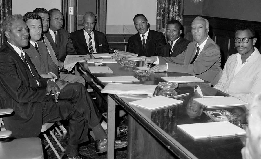 From left: civil rights leaders Bayard Rustin, Jack Greenberg, Whitney Young Jr., James Farmer, Roy Wilkins, Dr. Martin Luther King Jr., John Lewis, A. Philip Randolph, and Courtland Cox attending a summit, 1964