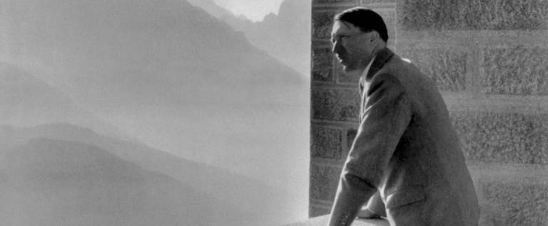 German Nazi Chancellor Adolf Hitler looking at the Obersalzberg Mountains from a balcony of his Berghof residence near Berchtesgaden in Germany, 1938. 