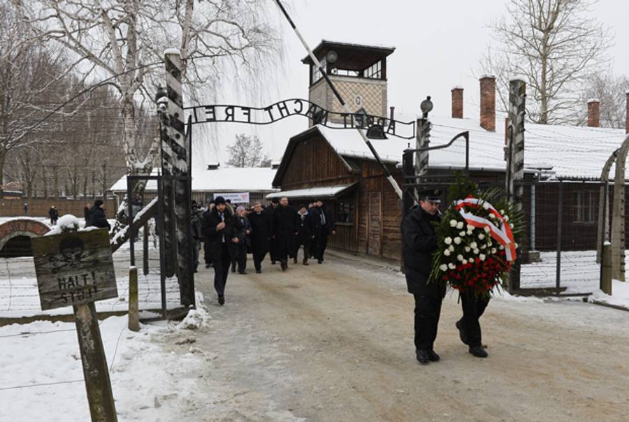 Polish President Bronislaw Komorowski, director of the Auschwitz-Birkenau museum Piotr Cywinski, and Auschwitz survivors arrive at the former concentration camp on January 27, 2015. (JANEK SKARZYNSKI/AFP/Getty Images)