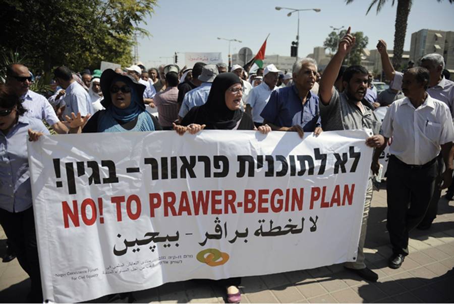 Bedouins hold a banner during a demonstration against Israeli government's plans to relocate Bedouins in the Negev desert, on July 15, 2013 in the southern city of Beersheva.(DAVID BUIMOVITCH/AFP/Getty Images)