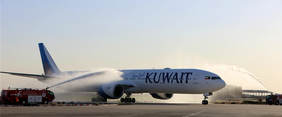 Airport officials spray water on the first Boeing 777-300ER ordered by Kuwait Airways after it landed at Kuwait International Airport on Dec. 9, 2016, in Kuwait City.