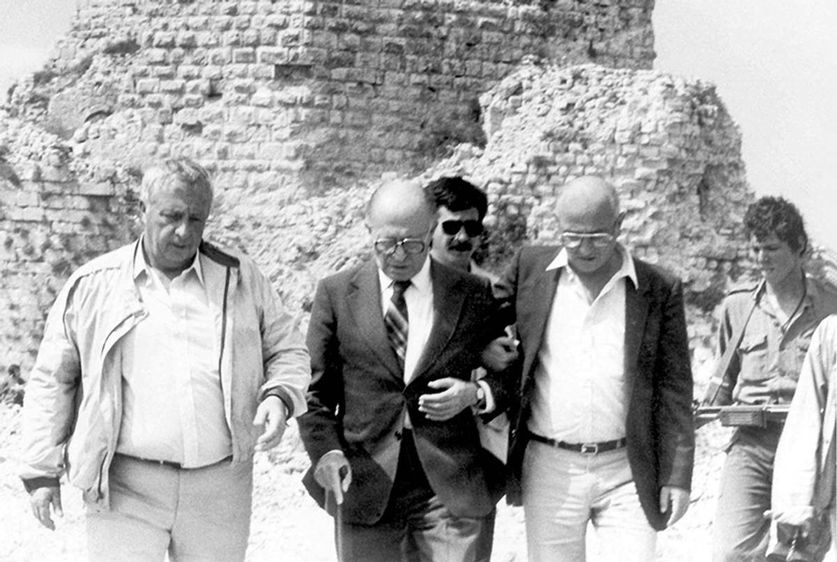 Then-Israeli Defense Minister Ariel Sharon (L) walks with Prime Minister Menachem Begin (C) and his spokesman June, 7, 1982, in Lebanon.(Uzi Keren/GPO/Getty Images)