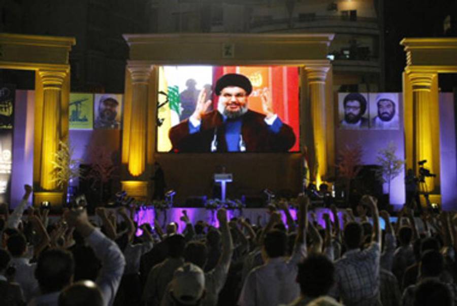 Lebanese Hezbollah supporters raise their fists up as the Shiite Muslim group's leader Hassan Nasrallah addresses the crowd through video link during a rally held in a southern Beirut suburb on August 14, 2009 to mark three years since the end of the war between Hezbollah and Israel.(Ramzi Haidar/AFP/Getty Images)