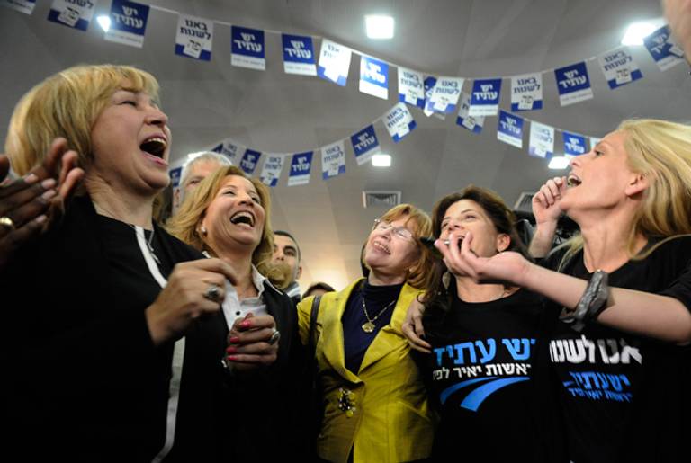 Supporters of Israeli actor, journalist and author Yair Lapid, leader of the Yesh Atid (There is a Future) party, react as the results of exit polls are announced giving the party 19 seats in the Kneset (Israeli parliament) on January 22, 2013 in Tel Aviv. ( DAVID BUIMOVITCH/AFP/Getty Images)