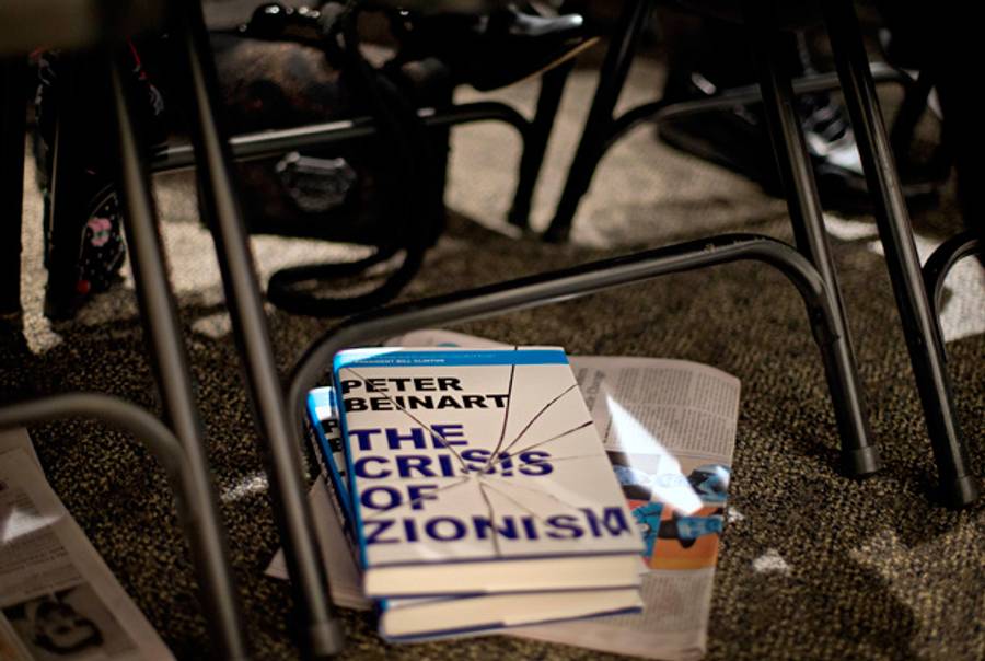 A copy of a book by author Peter Beinart under the chair of an audience member as Beinart speaks at an event in Atlanta, apart from the book fair, on Nov. 14, 2012.(David Goldman/AP)