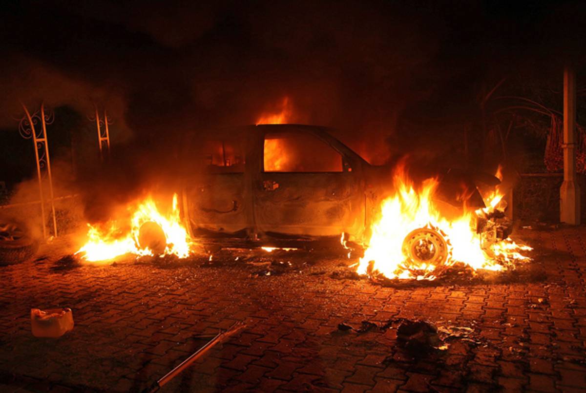 A vehicle and the surrounding area are engulfed in flames inside the U.S. consulate compound in Benghazi on September 11, 2012.(STR/AFP/GettyImages)