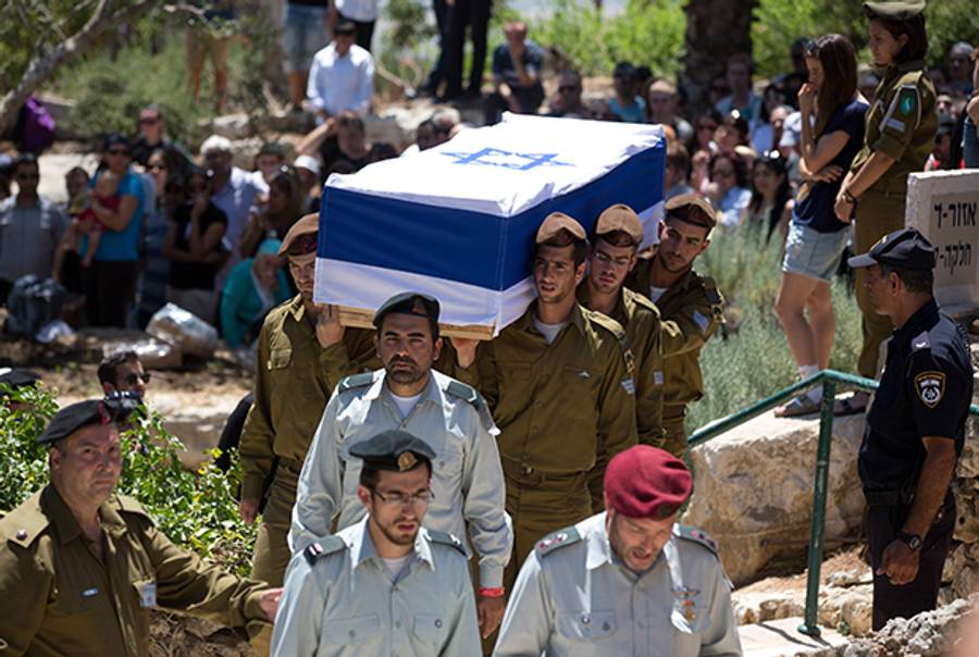 Israeli soldiers carry the coffin of their comrade Max Steinberg, draped with Israel's national flag, during his funeral on July 23 2014 at the Mount Herzl military cemetery in Jerusalem. (MENAHEM KAHANA/AFP/Getty Images)