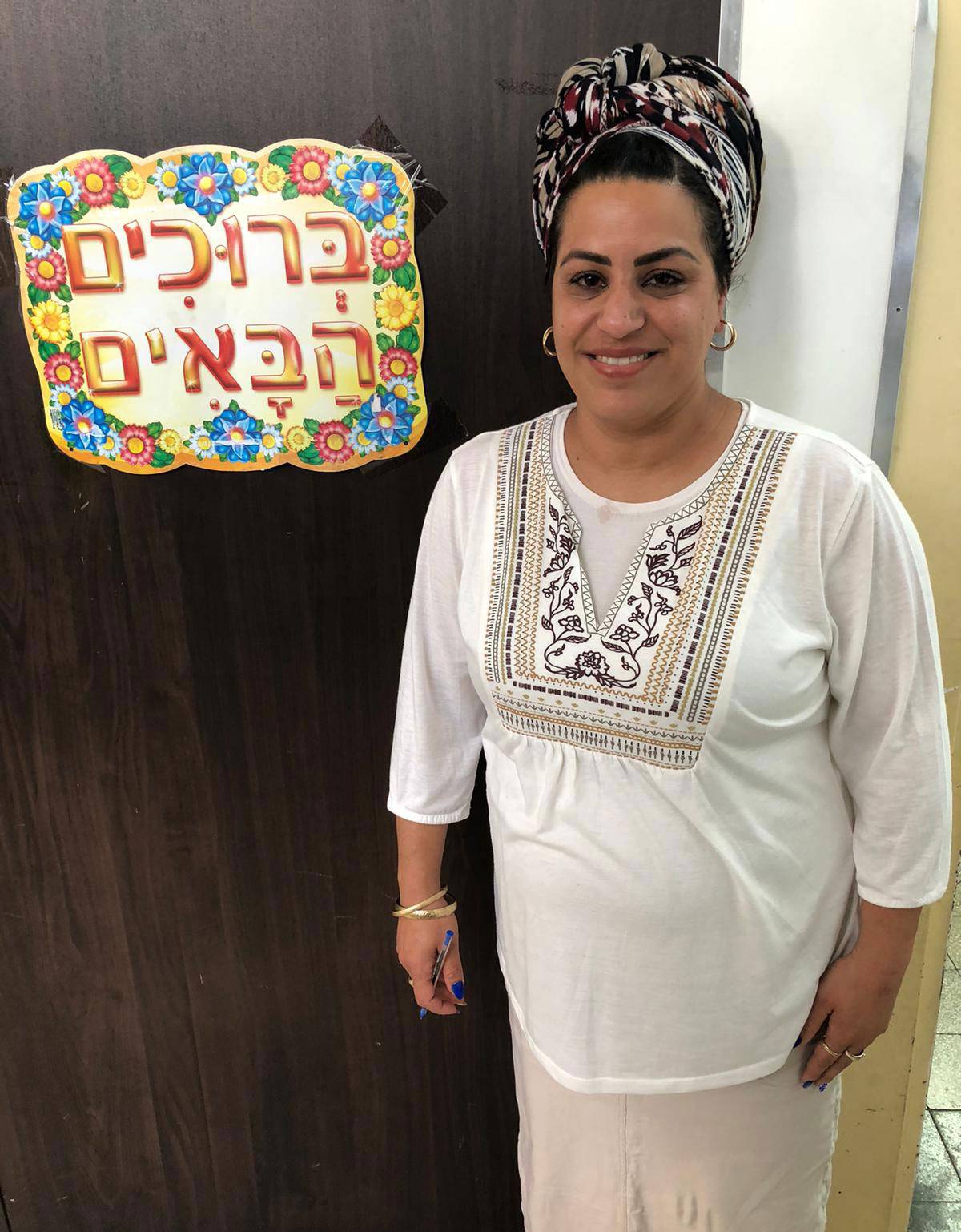 Shimrit Cohen at the door to the classroom where her mother nearly was killed in 1974