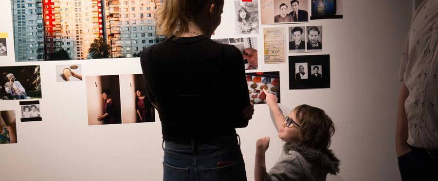 Visitors at the Museum of Jewish Montreal interact with an exhibit 