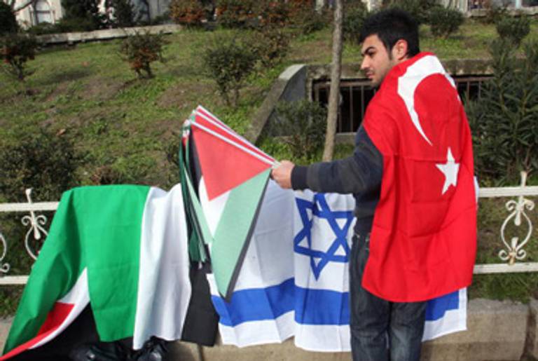 A vendor in Istanbul sells Israeli flags, for burning, and Palestinian flags, for waving, before a protest against Israel’s Gaza offensive last year.(Bulent Kilic/AFP/Getty Images)