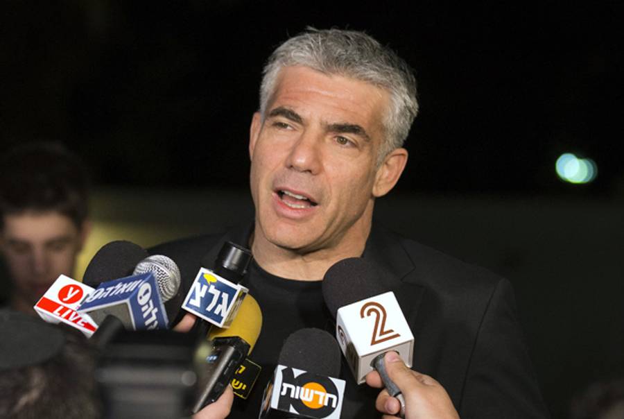 sraeli actor, journalist and author Yair Lapid, leader of the Yesh Atid (There is a Future) party, speaks to journalists on January 23, 2013 outside his home in Ramat Aviv, northern Tel Aviv. (JACK GUEZ/AFP/Getty Images)