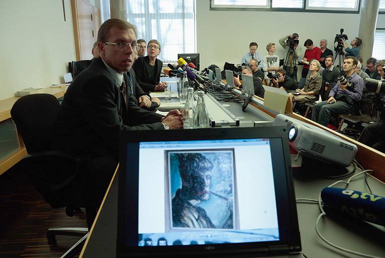 A self portrait by Otto Dix is seen on screen at a press conference on Nov. 5, 2013, in Augsburg, Germany, on the discovery of nearly 1,500 paintings, including works by Picasso and Matisse, looted by the Nazis.(Johannes Simon/Getty Images)