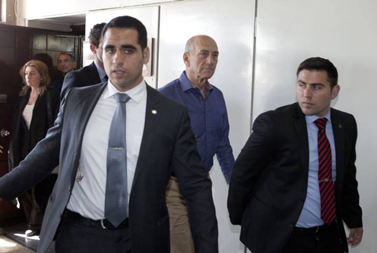 Former Israeli Prime Minister Ehud Olmert (C) leaves after a hearing in his trial for corruption linked to a major property development on March 31, 2014 at Tel Aviv District Court. (DAN BALILTY/AFP/Getty Images)