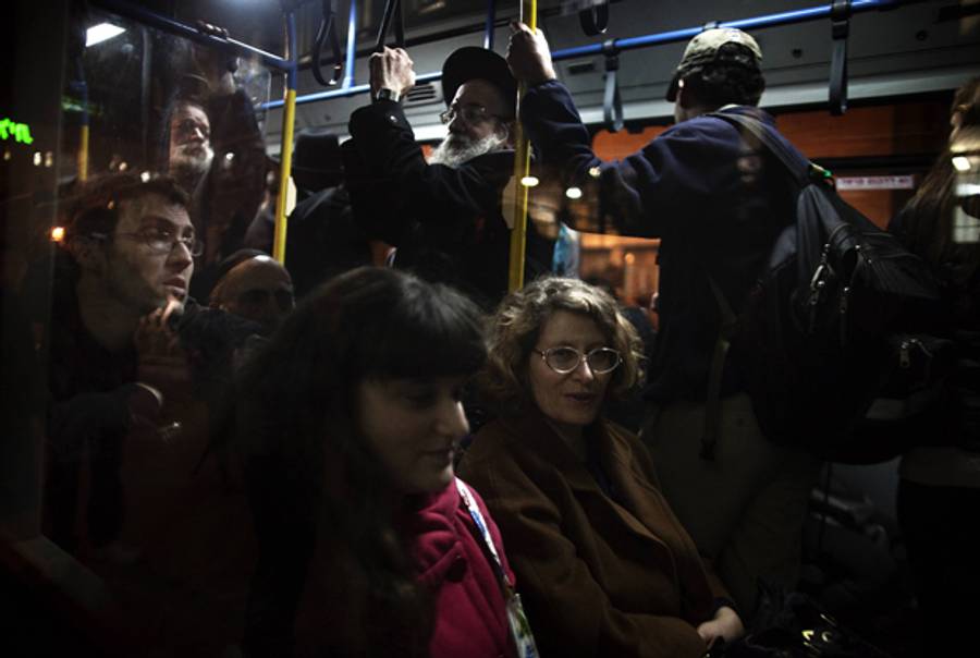Israeli women sit at the front of a bus in defiance of demands by hardliners that women sit at the back, in Jerusalem on Jan. 1, 2012.(Menahem Kahana/AFP/Getty Images)
