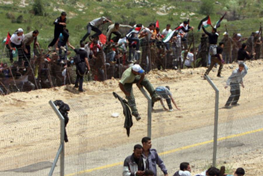 Palestinian Syrians storm the border at the Golan.(Jalaa Marey/AFP/Getty Images)