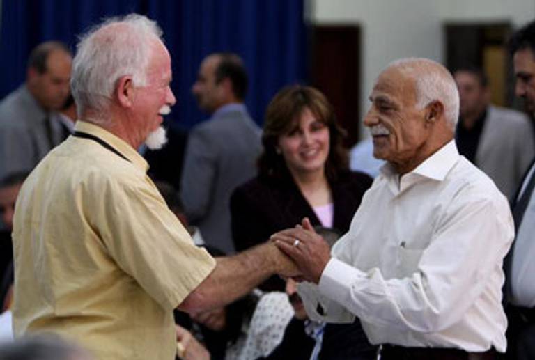 Davis, left, greets another Fatah member yesterday.(Abbas Momani/AFP/Getty Images)
