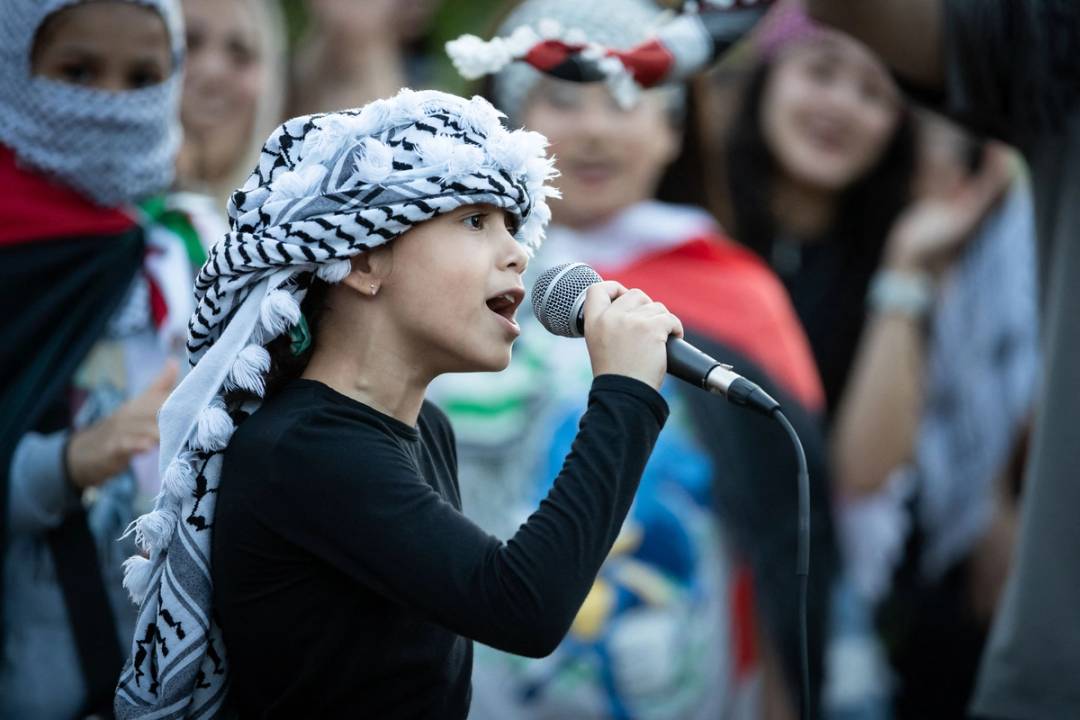 A young girl leads hundreds of people in chants in front of the White House as they protest against the Israeli operation in Rafah, May 28, 2024
