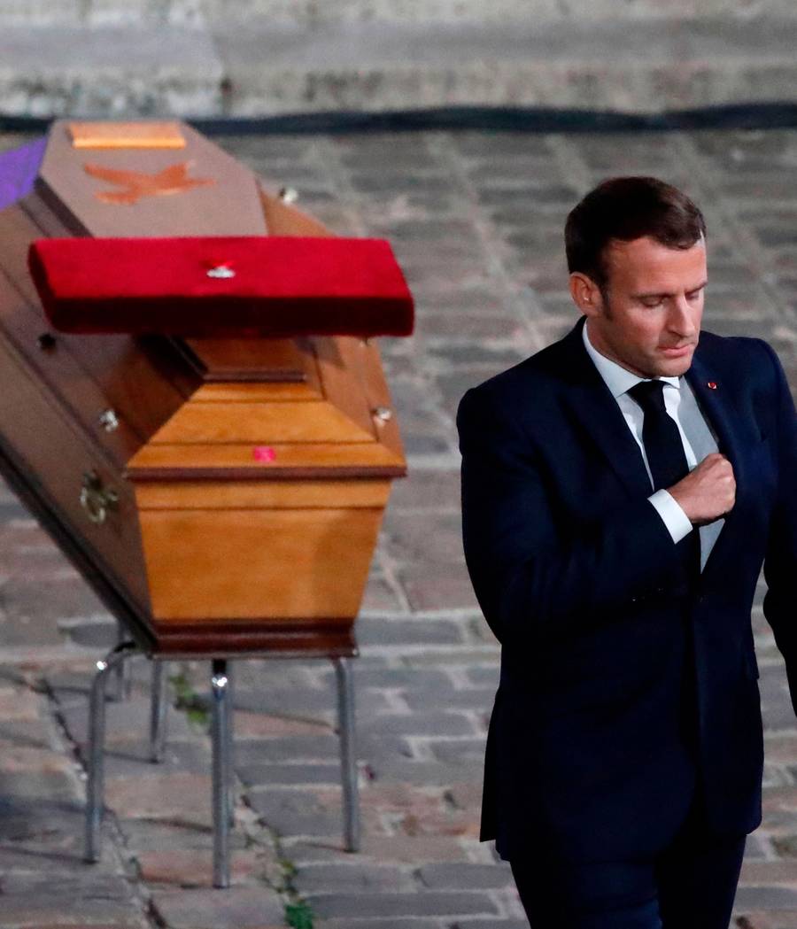 French President Emmanuel Macron pays his respects by the coffin of Samuel Paty, in Paris, Oct. 21, 2020