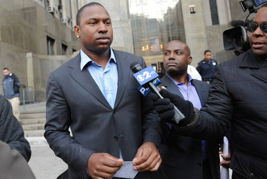 Detroit Tigers left fielder Delmon Young, left, exits Manhattan criminal court after posting bail on Friday, April 27, 2012, in New York. Young was arrested Friday on a hate crime harassment charge after police said he got into a fight with a group of men and yelled anti-Semitic epithets.(Louis Lanzano/AP)
