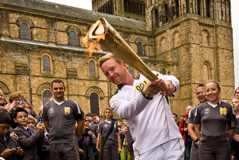 A cricketer in England with the Olympic Torch.(LOCOG via Getty Images)
