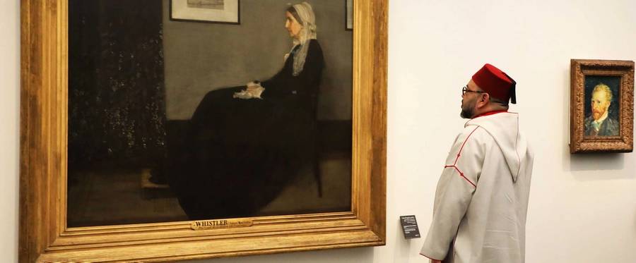 Moroccan King Mohammed VI looks at the painting 'Whistler's Mother' by James Abbott McNeill Whistler (1871) as he visits the Louvre Abu Dhabi Museum during its inauguration on Nov. 8, 2017, on Saadiyat island in the Emirati capital.