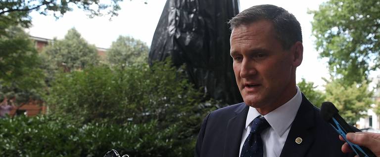 Mayor Mike Signer talks to reporters in front of the statue of Thomas Jonathan 'Stonewall' Jackson that is covered in a black tarp as it stands in Justice Park, formerly known as Jackson Park, on August 23, 2017 in Charlottesville, Virginia.