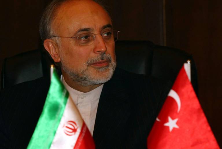 Iran's foreign minister yesterday, flanked by the Iranian and Turkish flags.(Adem Altan/AFP/Getty Images)